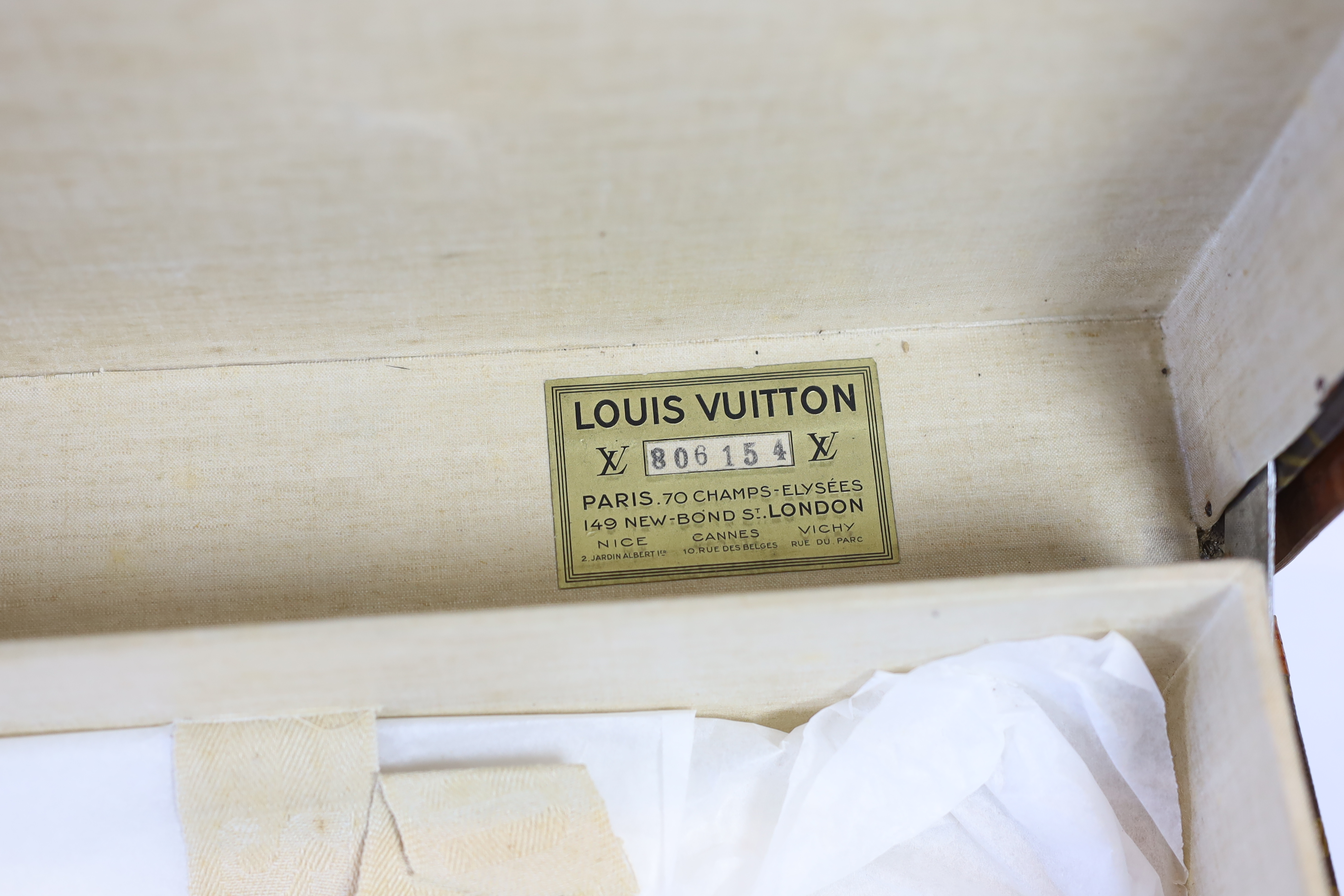 A vintage Louis Vuitton suitcase with monogram canvas and tan leather, width 71cm, height 44cm, depth 22cm